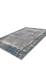 The ChromaBurst Premium Rug - Blue - MT176 is a modern, machine-made rectangular rug featuring a distressed abstract design in blue, gray, and beige, crafted from acrylic and viscose. Shown on a white background.