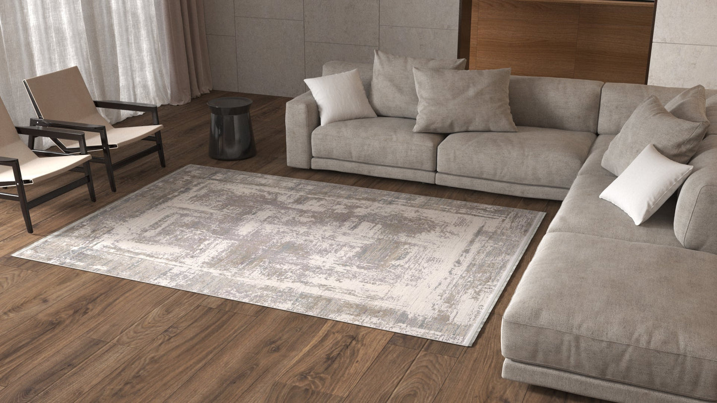 A modern living room with a large beige sectional sofa, light cushions, two beige armchairs, a small black side table, and the ChromaBurst Premium Rug - Bright - MT177 on wooden floors. Light pours in through sheer curtains.