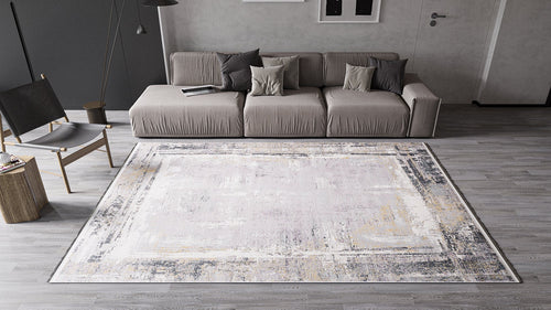 Load image 1 in gallery view. A modern living room featuring the ChromaBurst Premium Rug - Dark - MT175 on a gray wooden floor, with a taupe sofa, gray and beige pillows, a black chair, a round side table, and minimalist neutral-toned decor.