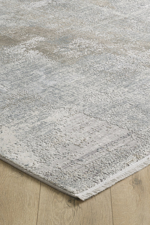 Load image 1 in gallery view. A close-up of the Chromatic Flair Contemporary Rug - Latte - M660D, featuring a subtle textured pattern in shades of grey, beige, and off-white on a natural wood floor.