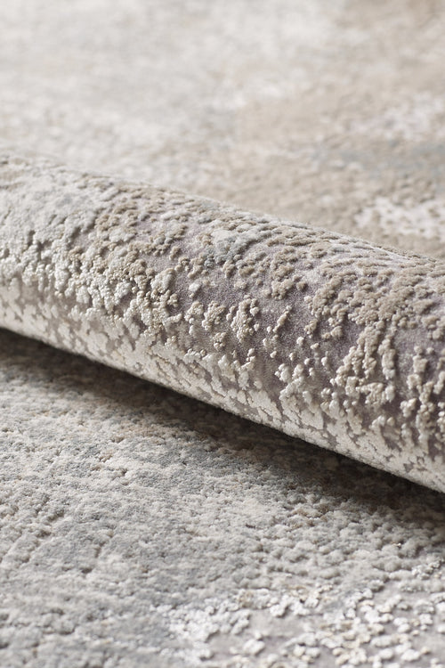 Load image 1 in gallery view. A close-up of the Chromatic Flair Contemporary Rug - Latte - M660D reveals its soft, uneven surface in beige and gray tones with a subtle pattern.