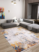 Modern living room with a large gray sectional, a colorful abstract painting, and the Chromatic Kaleidoscope - Washable Rug - JR1483, ideal for high-traffic areas. A cozy window nook features soft cushions and a throw blanket for relaxing moments.