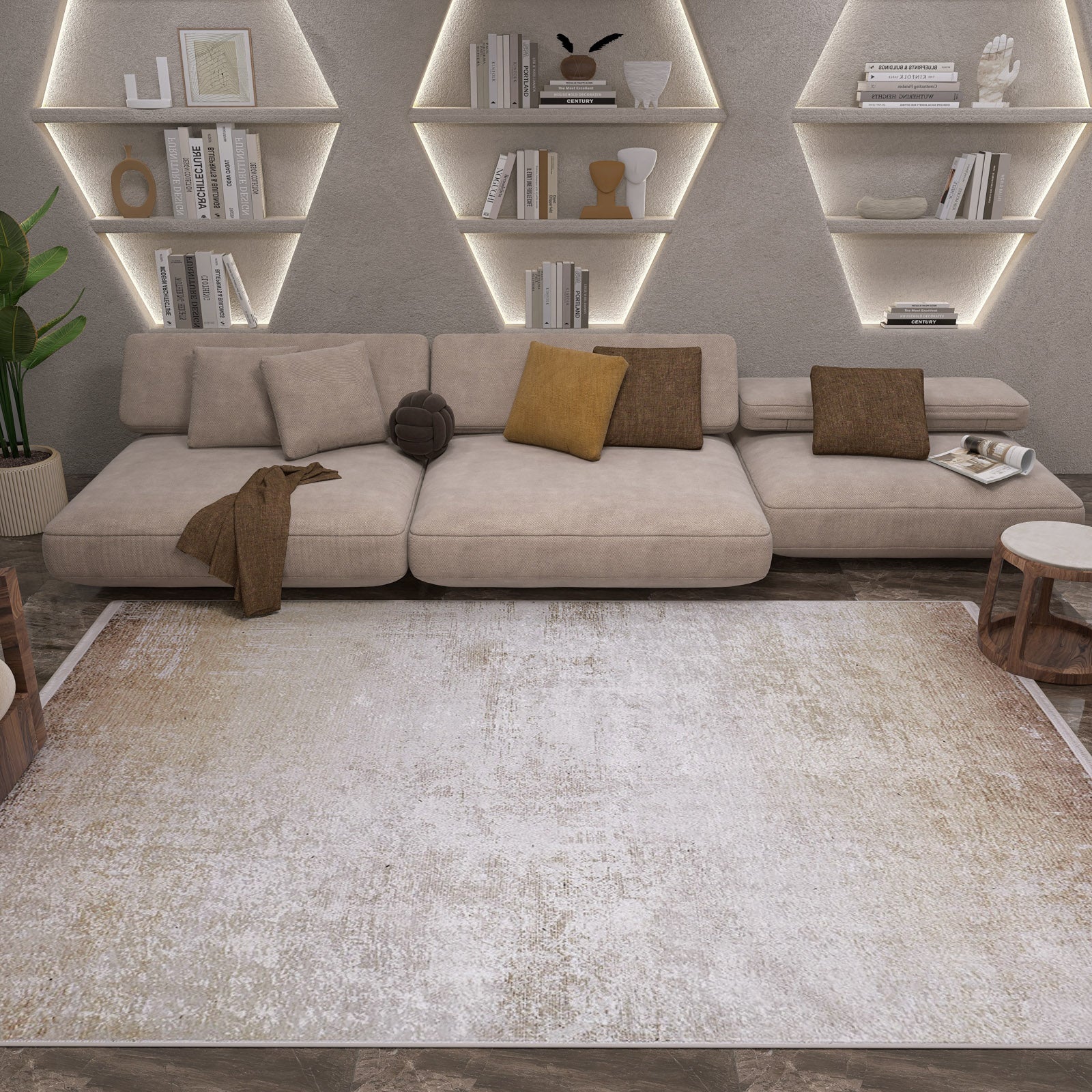 A modern living room features a beige sectional, brown accent pillows, wooden tables, geometric shelves with books and decor softly lit, and the Cinnamon Swirl - Washable Rug - JR425 in cream and beige—perfect for high-traffic areas.
