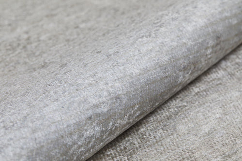 Load image 1 in gallery view. A close-up of the Cinnamon Swirl - Washable Rug - JR425 (Custom Size), showing its light gray, textured surface with a subtle metallic sheen—perfect for flat weaves or coordinating with cream and beige rugs.