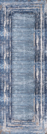 The Classic Bordered - Washable Rug - JR1197 is a rectangular, blue gradient rug with a lighter center, darker and white distressed borders, subtle beige hints, and layered look. It's washable and ideal for high-traffic areas.