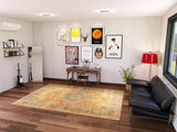 A modern, cozy room with a desk, wall art, black leather sofa, red floor lamp, large window, mirror, shelves of books, two guitars, and the Classic Laurel - Washable Rug - JRN1022. A potted plant sits by the sofa on wooden flooring.