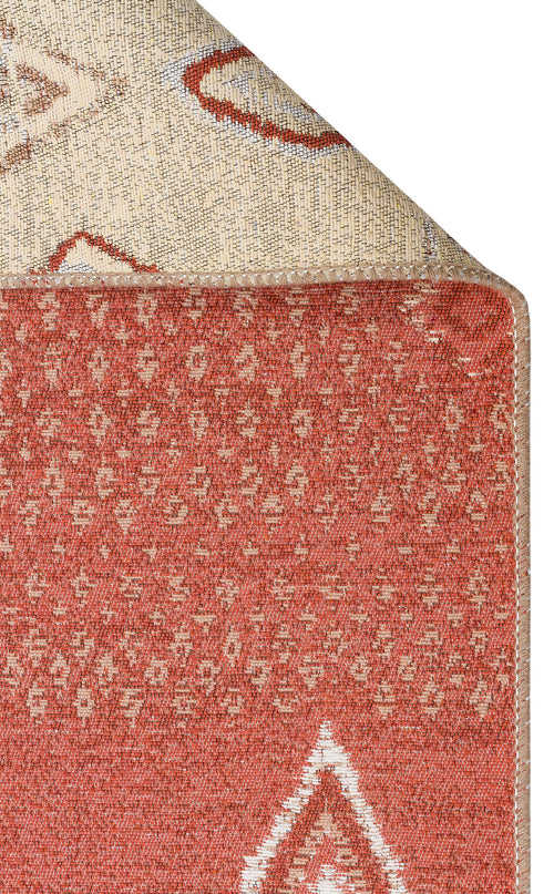 Load image 1 in gallery view. A close-up of the Clay Blend - Washable Double-Sided Kilims - AR37 rug in rust tones with cream geometric designs, corner flipped to reveal its lighter patterned underside—ideal for bohemian home decor.