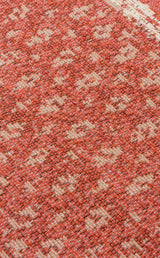 Close-up of the Clay Blend - Washable Double-Sided Kilims - AR37, featuring visible orange and beige woven threads with a subtle, irregular pattern and textured finish—ideal for adding a bohemian touch to your home decor.