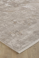 A close-up of the Cloudscape Geometry Modern Rug - M533B in beige and light brown on a light wood floor, highlighting its subtle geometric patterns, textured details, and stylish machine-made finish near the edge.