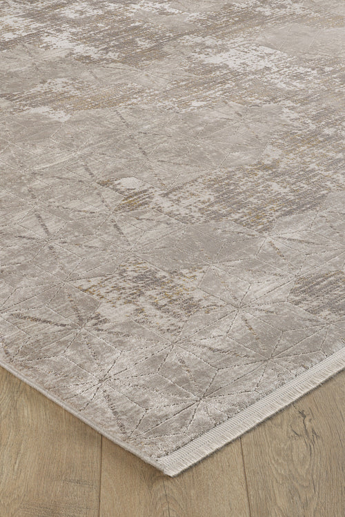 Load image 1 in gallery view. A close-up of the Cloudscape Geometry Modern Rug - M533B in beige and light brown on a light wood floor, highlighting its subtle geometric patterns, textured details, and stylish machine-made finish near the edge.