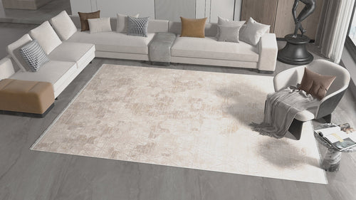 Load image 1 in gallery view. Modern living room featuring the Cloudscape Geometry Modern Rug - M533B, a white sectional with throw pillows, beige ottoman, gray armchair with blanket, and a side table with magazines. Neutral tones and minimalist decor complete the space.