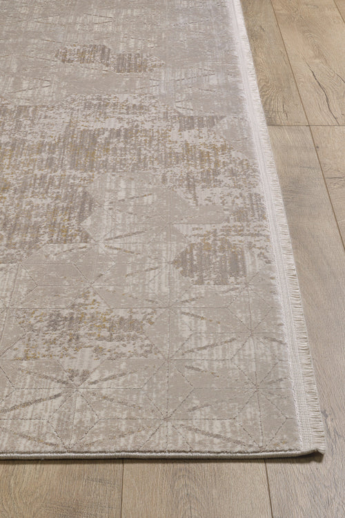 Load image 1 in gallery view. The Cloudscape Geometry Modern Rug - M533B, in beige and light brown with subtle geometric and abstract details and fringed edges on one side, is displayed on a wooden floor.