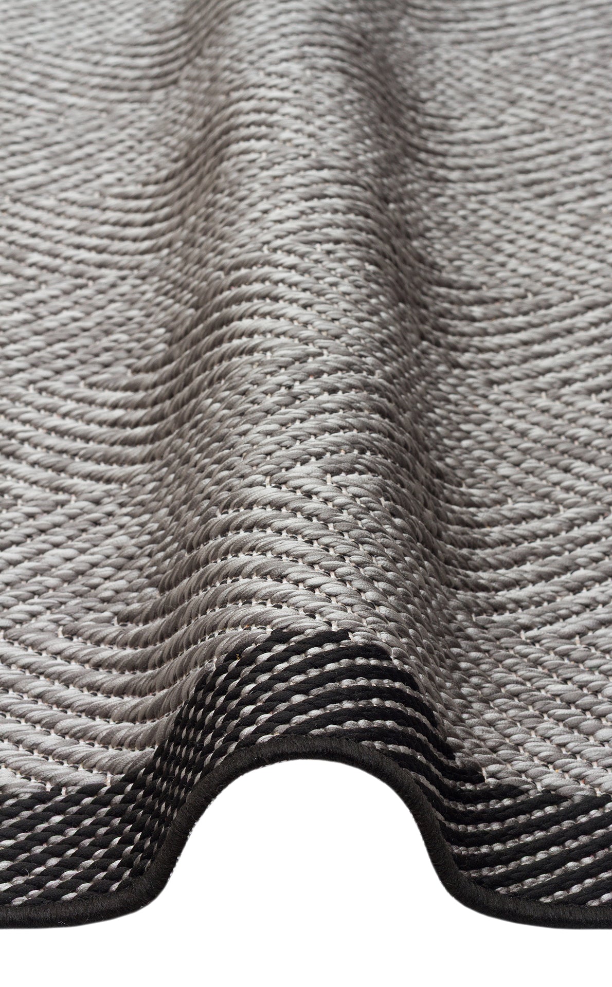 A close-up of the Coal Texture - Kilim - MNO02 shows its intricate gray flat weave and wavy, textured surface, highlighting the detailed pattern of this woven rug.