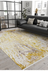 A modern living room features a black sofa, decorative cushions, potted plants, light wood floors, large windows with natural light, and the Color Splash - Washable Rug - JR146 (Custom Size) in yellow and white.