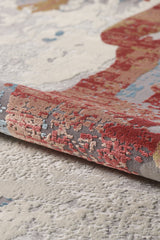 A close-up of the Colorful Chaos Premium Rug - M313P, a machine-made oriental rug with a textured surface and an abstract red, gray, beige, and blue pattern. The soft rug features raised, colorful designs for added dimension.