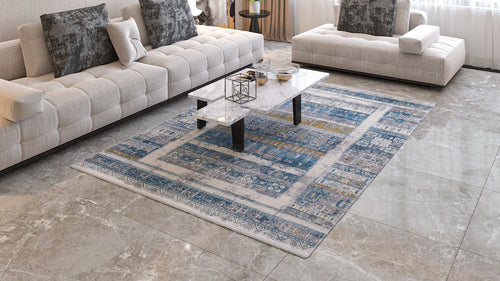 Load image 1 in gallery view. A modern living room features two cream sofas, a white marble coffee table, and the Cool Nomadica Premium Rug - M366B on a glossy tiled floor. Large windows bring in light, while decorative pillows add coziness.