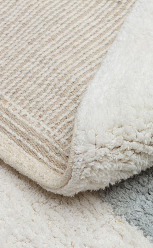 Load image 1 in gallery view. A close-up of the Cozy Puzzle - Washable Shaggy - CBN07 rug displays its soft, fluffy surface and flat, woven backing, with a corner flipped to reveal both textures.