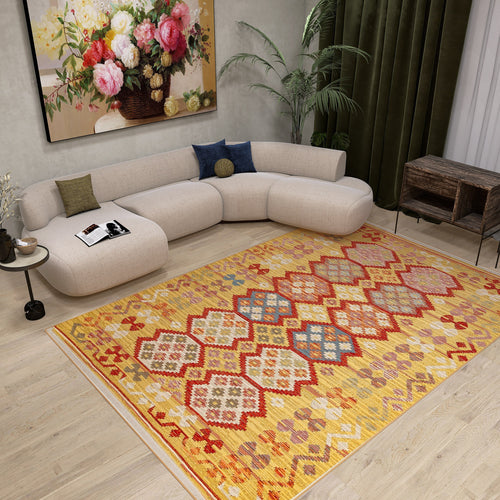 Load image 1 in gallery view. A modern living room with a curved beige sofa, the Crimson Dot - Kilim - NMD03 polyester flat weave rug, a round side table, green curtains, wooden furniture, a large leafy plant, and a floral painting on the wall.