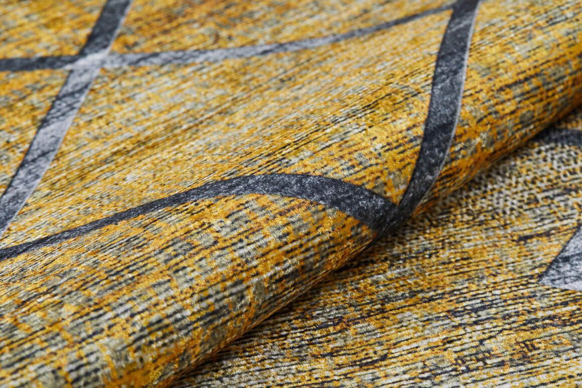 Close-up of the Crossed Connections - Washable Rug - JR1181 (Custom Size), featuring a textured yellow and gray surface with mottled patterns and intersecting dark lines—washable, durable, and ideal for high-traffic areas; fabric shown slightly folded in front.