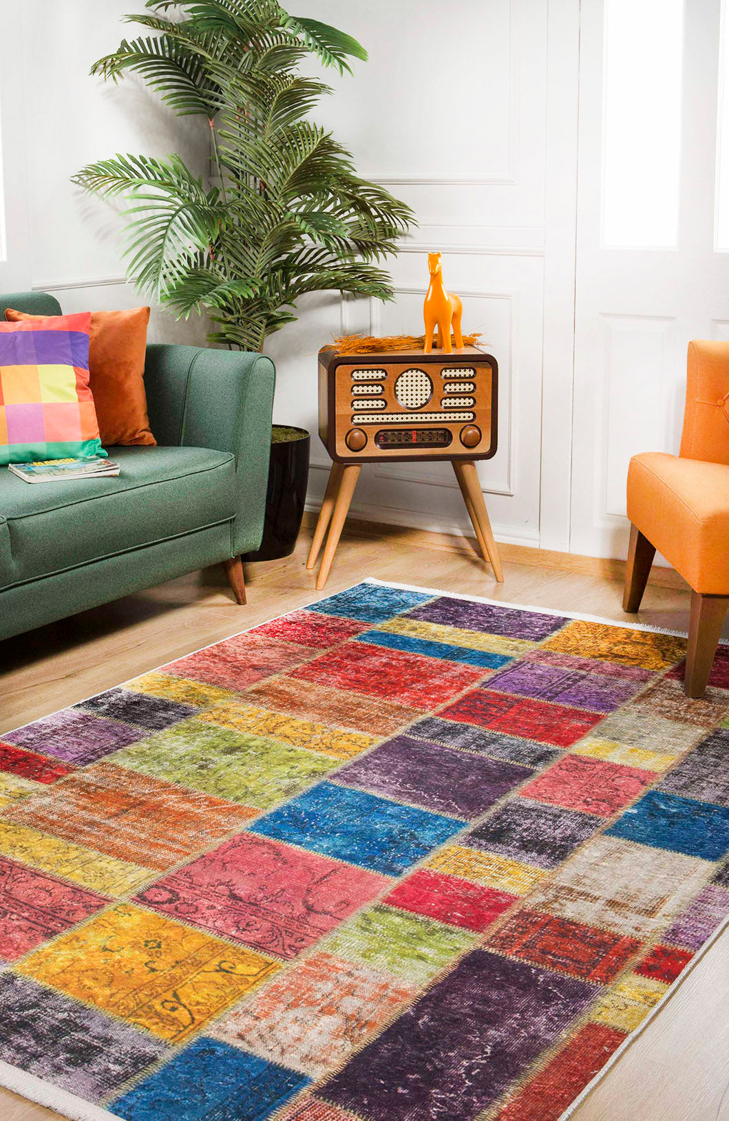 The Crosshatch Craze - Washable Rug - JR210 (Custom Size) brightens this modern living room, lying on a wooden floor near a green sofa with colorful cushions, an orange chair, retro radio, yellow dog figurine, and a large potted plant. Ideal for high-traffic areas.