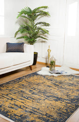 A modern living room with a white sofa, patterned cushion, large potted plant, Diagonal Dash - Washable Rug - JR1310 (Custom Size) in abstract blue and gold, white fur rug, decorative birdcage, golden statue, and magazines on a wooden floor.