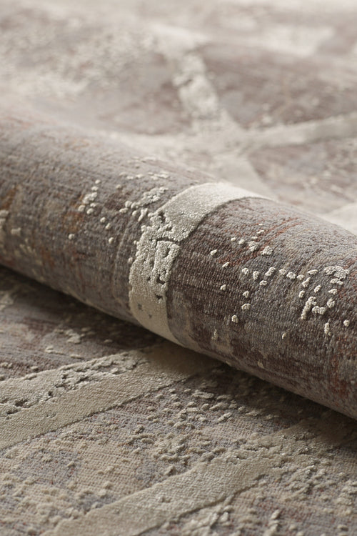 Load image 1 in gallery view. A close-up of the Dominant Lineage Modern Rug - Bright - M633M, featuring rolled, textured geometric patterns in earthy tones with abstract raised detailing and a blend of beige, brown, and taupe.