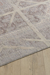 A corner of the Dominant Lineage Modern Rug - Bright - M633M features intersecting cream lines on a mottled gray and beige background, displayed on a light wood floor.