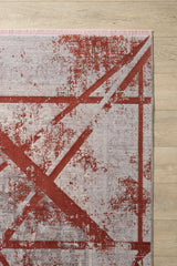The Dominant Lineage Modern Rug - Coral (HRD003) features an abstract red geometric design on a light grey background. Displayed on a light wood floor, only one corner of the rug is visible.