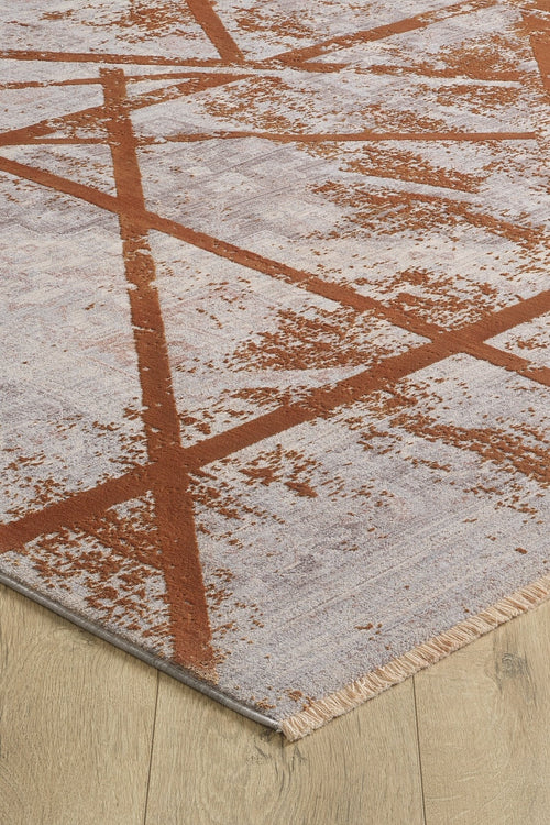 Load image 1 in gallery view. A close-up of the Dominant Lineage Modern Rug - Tangerine - HRD007 shows its abstract rust-colored lines and splatters on a light gray background, short beige fringe along the edge, and placement on a wooden floor.