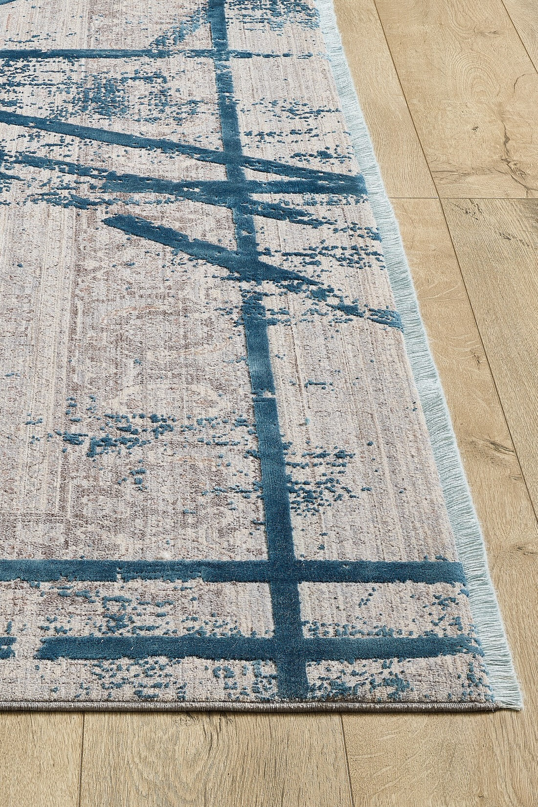 The Dominant Lineage Modern Rug - Teal - HRD010 features a beige base with abstract blue lines, a textured machine-made design, and fringed edges—perfect for adding modern style to any room.