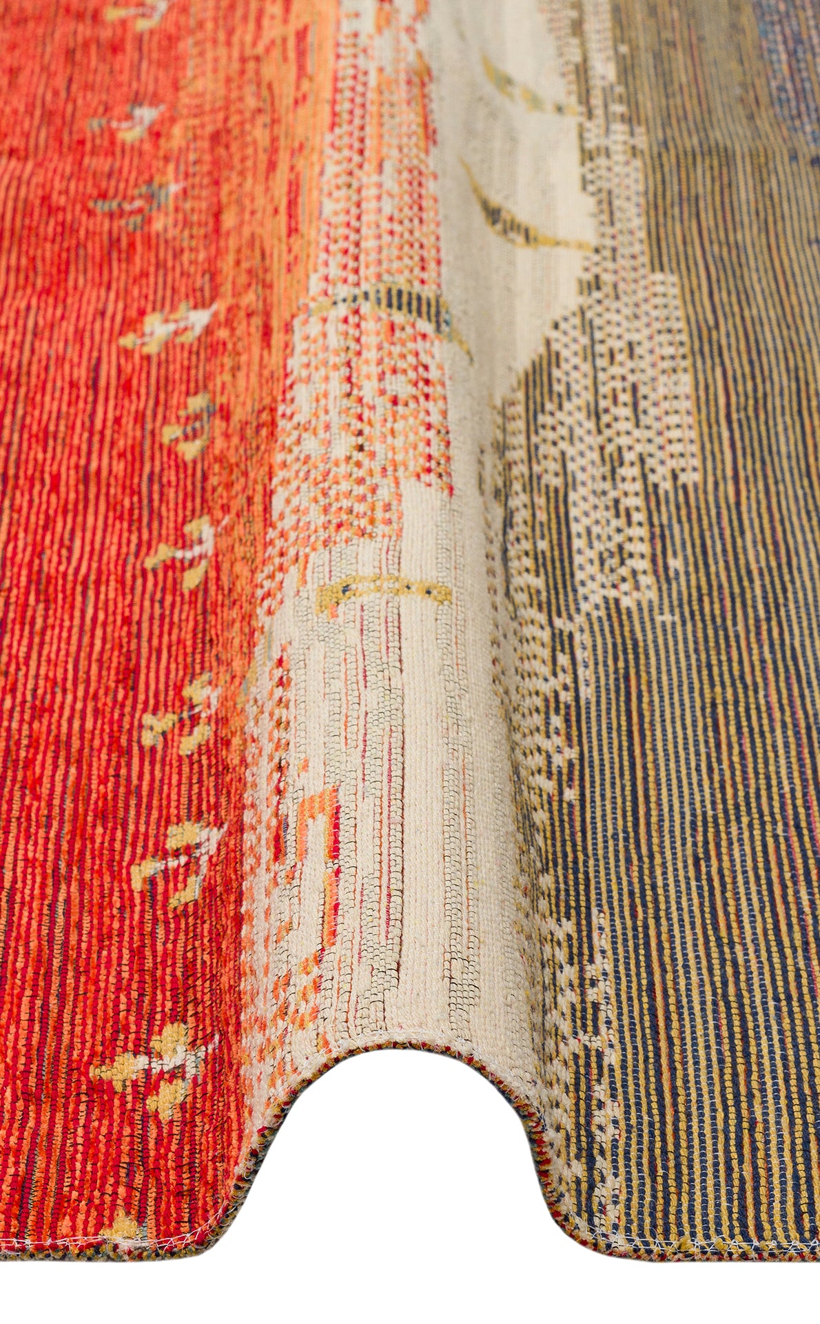A close-up of the Dust Trace - Kilim - NMD12 shows a wavy fold, highlighting its gradient red, beige, and blue tones with subtle geometric and dotted patterns woven into the modern rug.