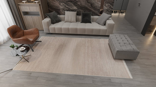 Load image 1 in gallery view. Modern living room with a beige sofa, brown leather chair, gray bench, glass coffee table, and the Earthy Textures Neutral Rug - M497J on gray wooden flooring. A marble-patterned accent wall sits behind the sofa.