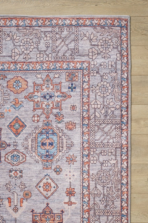 Bild 1 in Galerieansicht laden. The Echelon Bordered Washable Rug - LCC3018 (Custom Size) features intricate blue, orange, and cream geometric and floral patterns on a light wooden floor—perfect for high-traffic areas.