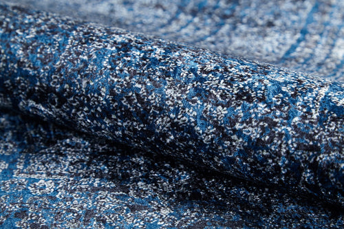 Load image 1 in gallery view. Close-up of a rolled-up Elegant Vine - Washable Rug - JR1847 (Custom Size) featuring a blue and white abstract pattern with a slightly shiny, textured surface—perfect for high-traffic areas.
