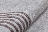 Close-up of the Elegant and Chic - Washable Rug - JR1509 (Custom Size) shows a soft, textured gray surface with dark parallel stripes, offering a premium marbled look. It’s ideal for high-traffic areas thanks to its washable design.