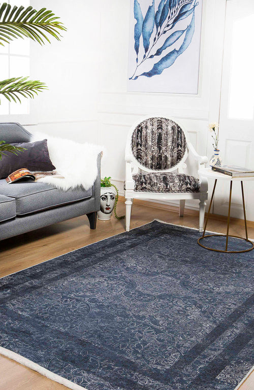 Bild 1 in Galerieansicht laden. A stylish living room featuring a gray sofa, white fur throw, artistic chair, round side table with vase, large Elegant and Modern - Washable Rug - JR1297 (Custom Size) ideal for high-traffic areas, decorative face planter, and blue leaf wall art.