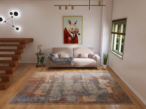 Load image 1 in gallery view. A modern living room with a beige sofa, two cushions, a throw, the Enchanted Threads - Washable Rug - JRS002 (Custom Size) for allergy-sensitive high-traffic areas, plus a potted plant, animal wall art, wooden stairs, and window blinds.