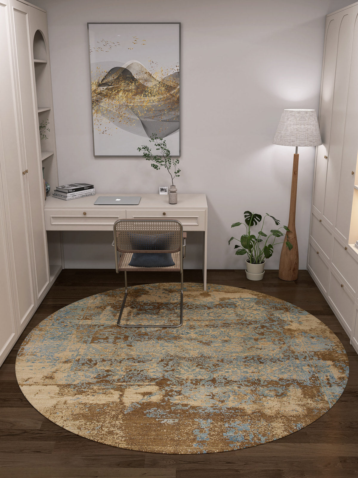 A cozy home office with a white desk, laptop, chair, and the Enchanted Threads Washable Rug—JRS002 (custom size) in blue and brown, ideal for high-traffic or allergy-sensitive areas. Finished with a tall lamp, potted plant, wall art, and shelves.