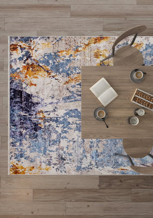 Load image 1 in gallery view. A top-down view of a modern dining table with two chairs sits on the Enigmatic Elegance - Washable Rug - JR787 (Custom Size); coffee, a book, and snacks rest on the table. The light wood floor adds warmth—perfect for high-traffic spaces.