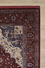 A close-up of the Ethereal Garden Medallion Rug - Burgundy - 2222A shows intricate Persian-style patterns in burgundy, cream, blue, and beige on a light wood floor, with only the corner of the machine-made rug visible.