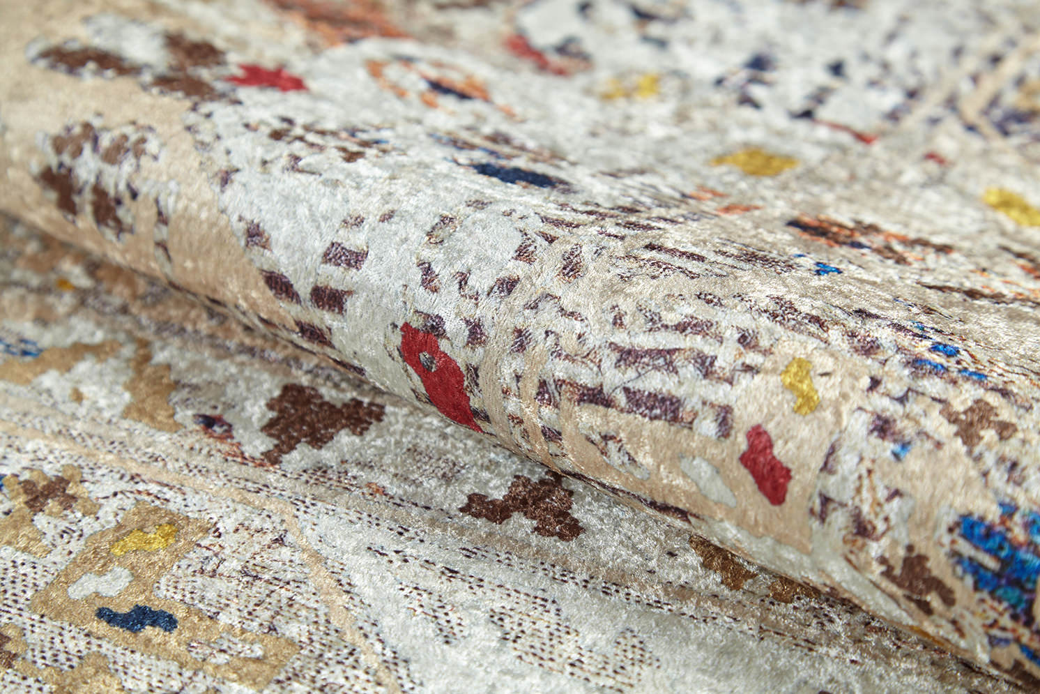 A close-up of the Ethno Expanse Machine-Washable Rug (JR5046, Custom Size), featuring abstract beige, cream, red, blue, and yellow patterns, detailed weaving, and a slightly raised soft texture.