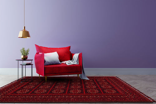 Load image 1 in gallery view. A modern living room featuring a red velvet sofa, white and gray pillows, light throw, potted plant on a side table, gold hanging lamp, Fire Ripple - Kilim - BHR03 rug with Turkish inspiration, and a lavender wall background.