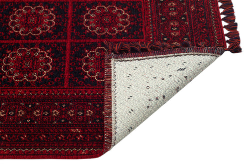 Load image 1 in gallery view. The Fire Ripple - Kilim - BHR03 features a red patterned chenille weave with ornate designs. One corner is flipped, showing the plain white underside with minimal decoration.