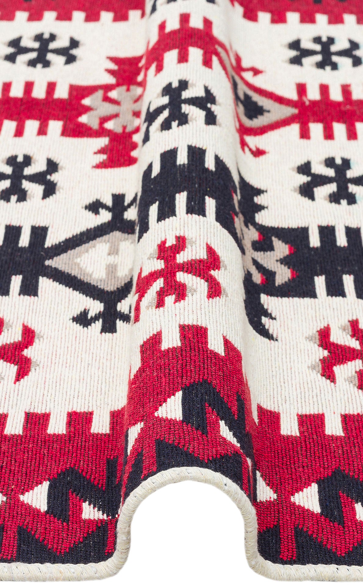 A close-up of the Flame Line - Washable Reversible Kilims - AR32, showing a bold red, black, and cream geometric pattern with a folded edge featuring zigzag and star motifs.