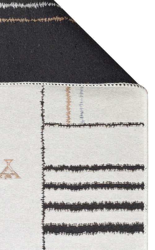 Bild 1 in Galerieansicht laden. A close-up of the Fog Detail - Washable Double-Sided Kilims - AR40 shows thick black lines on a white background with a solid black edge. The kilim also features subtle tan and gray accents in its design.