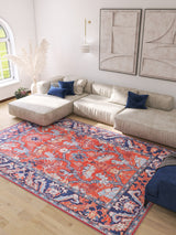 A bright living room with a large beige sectional sofa, blue accent pillows, the Galea Turkish-Design Coral Washable Rug (LCC3027) for high-traffic areas, light wood floors, pampas grass in a vase, and modern abstract art on the wall.