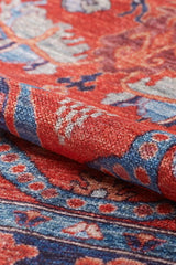 Close-up of the Galea Turkish-Design Coral Washable Rug (LCC3027), rolled to reveal detailed floral and geometric patterns in red and blue, with fine texture and visible fibers—perfect for high-traffic spaces.