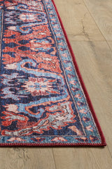 A close-up of the Galea Turkish-Design Coral Washable Rug - LCC3027 (Custom Size) shows vibrant red, blue, and white patterns on a light wood floor. This washable rug’s intricate motifs and durable design suit high-traffic areas perfectly.
