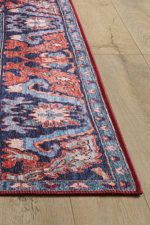 Load image 1 in gallery view. A close-up of the Galea Turkish-Design Coral Washable Rug - LCC3027 (Custom Size) shows vibrant red, blue, and white patterns on a light wood floor. This washable rug’s intricate motifs and durable design suit high-traffic areas perfectly.
