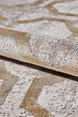 A close-up of the Geometric Down Mid Century Modern Rug - M534B in beige and gold, showcasing intersecting geometric shapes with a raised, textured surface and a soft, plush look.